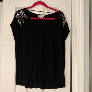 Black short sleeve top adorned with black rhinestones on the shoulders.